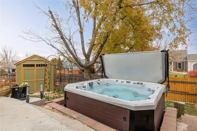a view of roof deck with table and chairs under an umbrella