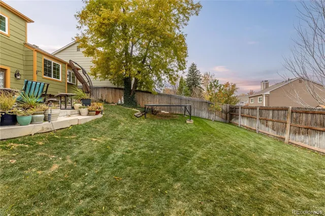 a view of backyard with outdoor seating and green space