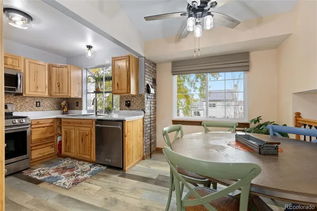 a kitchen with sink cabinets dining table and chairs