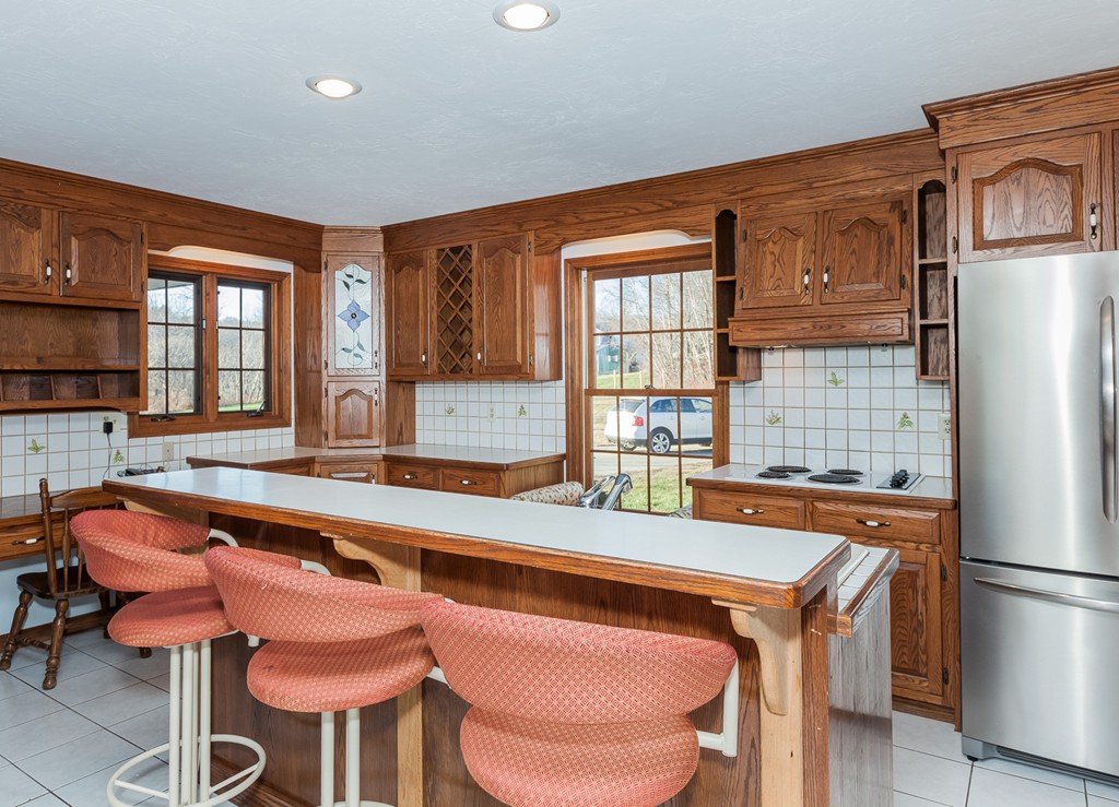 30 Main Road Montgomery, MA 01085 - Photo 13 of 30 a dining table chairs and a refrigerator in a kitchen