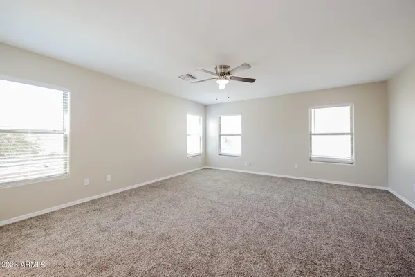 a view of an empty room with a ceiling fan