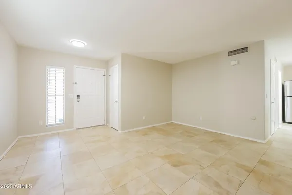 a view of a livingroom with a ceiling fan and window
