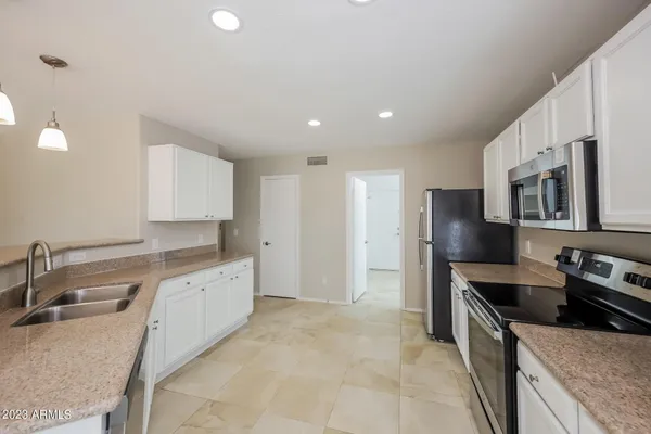 a kitchen with stainless steel appliances granite countertop a sink and stove top oven