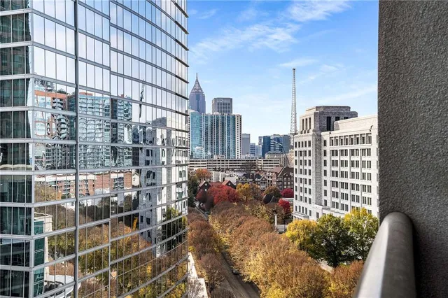 a view of a workspace with furniture and window