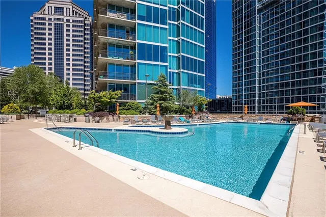 a swimming pool with outdoor seating and yard