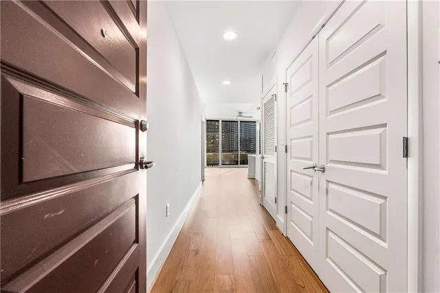 a large white kitchen with stainless steel appliances granite countertop a stove and cabinets