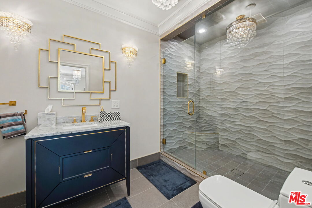 204 Foothill Road Beverly Hills, CA 90210 - Photo 25 of 38 a bathroom with a toilet a sink and mirror