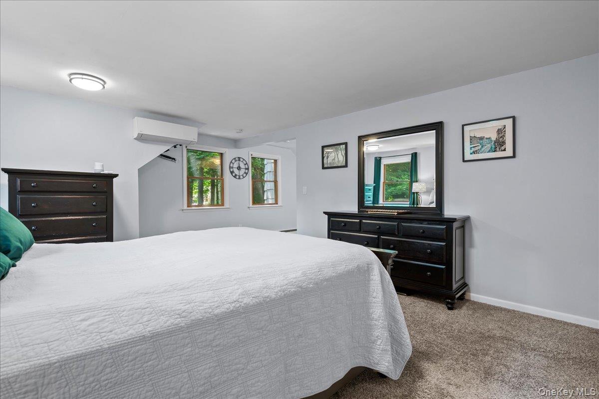 105 High St Extension Mount Kisco, NY 10549 - Photo 31 of 38 a bedroom with a bed and a dresser