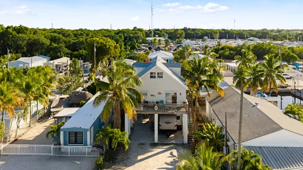 an aerial view of multiple houses with yard