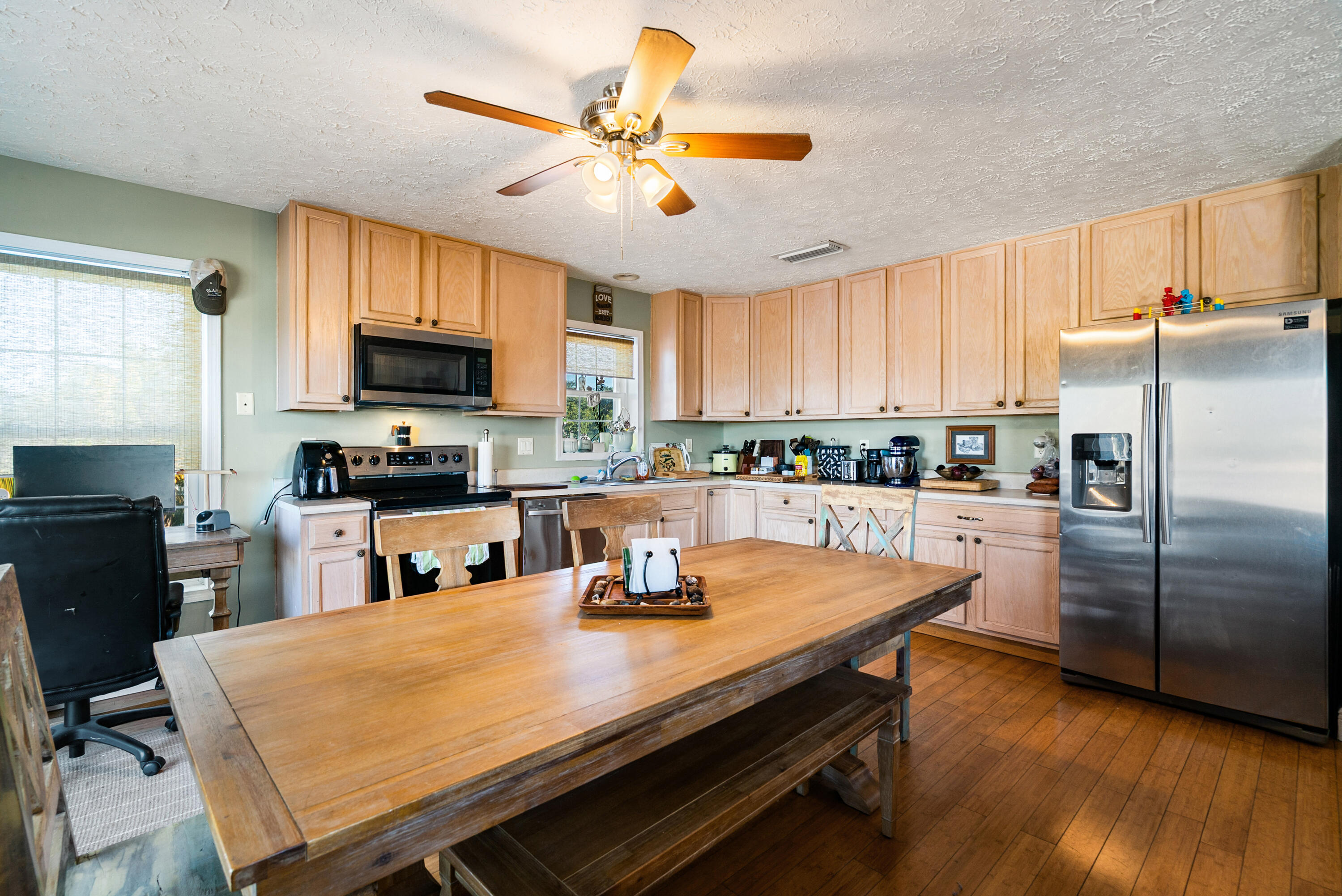 192 2nd Court Key Largo, FL 33037 - Photo 8 of 44 a kitchen with stainless steel appliances granite countertop a sink a stove a refrigerator cabinets a dining table and chairs