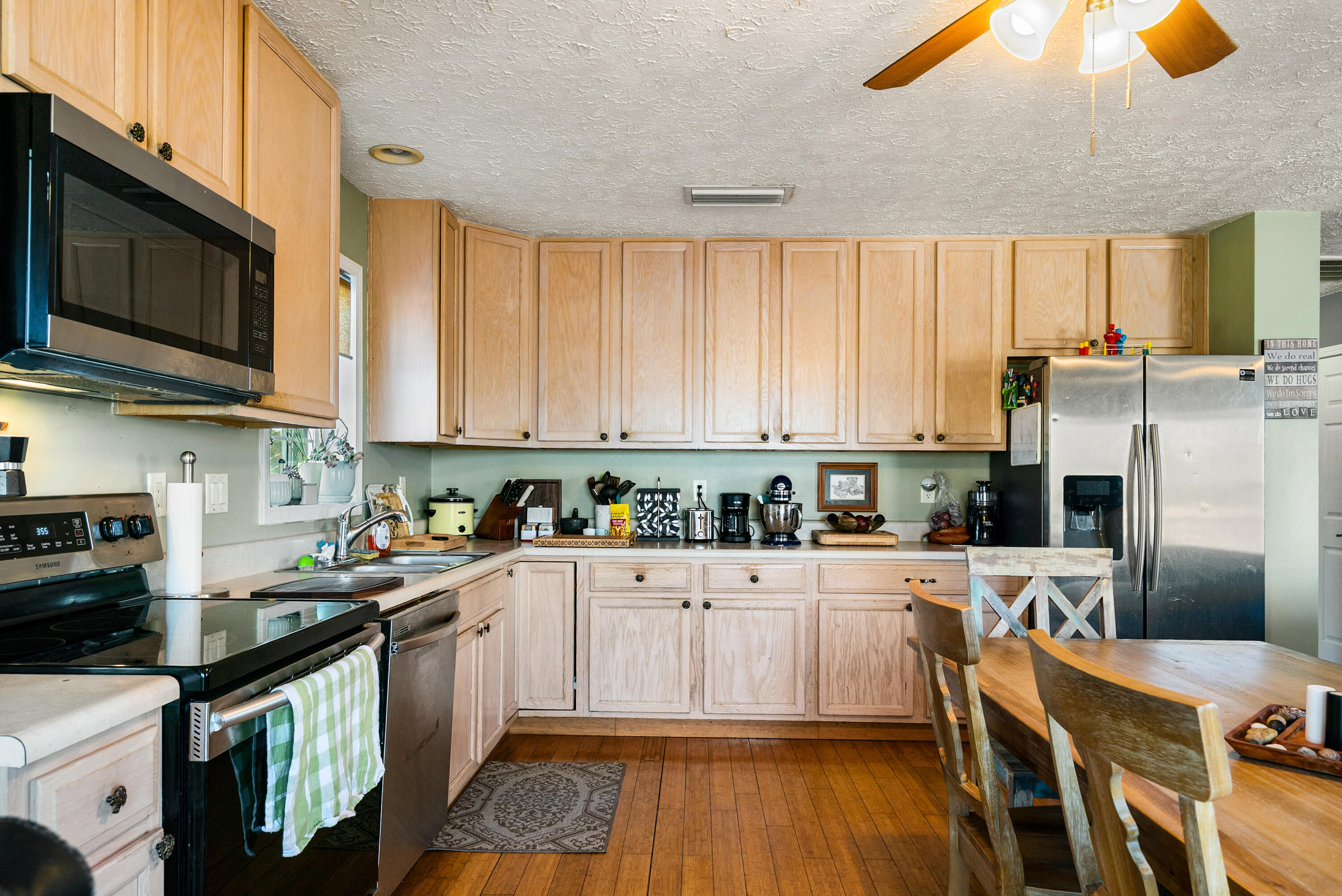192 2nd Court Key Largo, FL 33037 - Photo 10 of 44 a kitchen with stainless steel appliances a stove top oven a sink a refrigerator cabinets and dining table