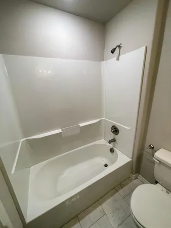 a bathroom with a bathtub and toilet