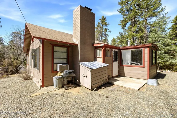a front view of a house with yard outdoor seating and barbeque oven