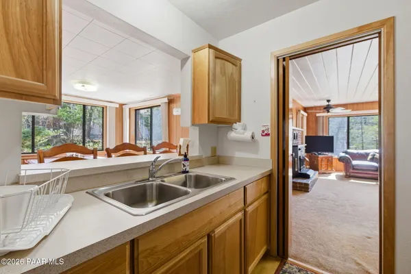 a view of a kitchen with a sink and living room