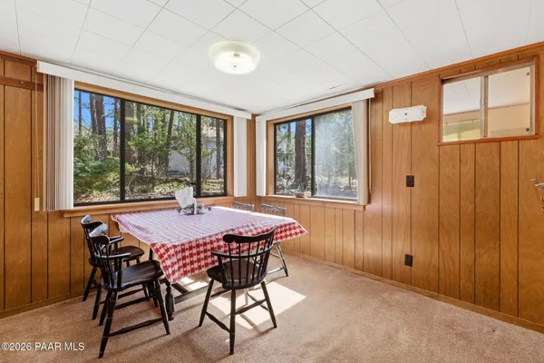 a dining room with furniture and window