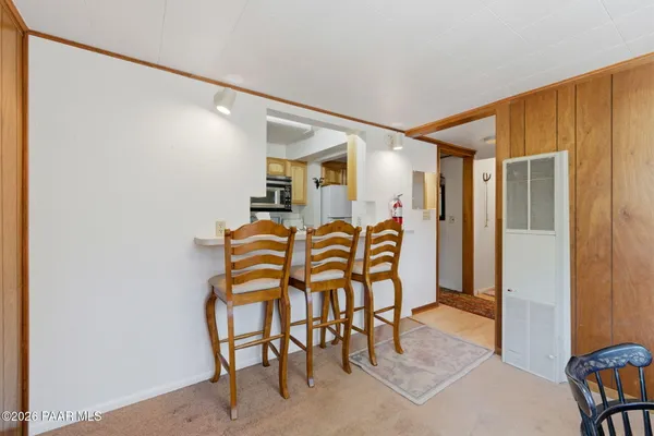 a dining room with furniture and window