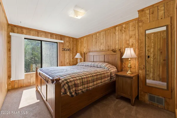 a bedroom with a bed and a dresser