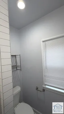 a bathroom with a toilet and a shower