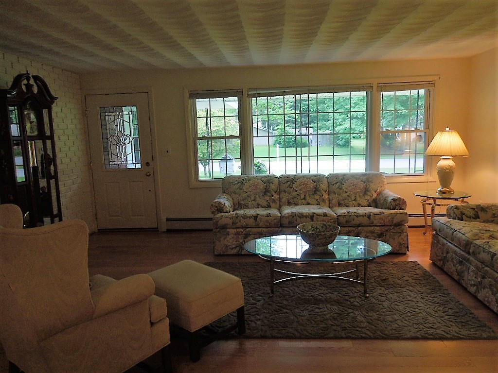 8 Howard Road Chelmsford, MA 01824 - Photo 16 of 30 a living room with furniture and a large window