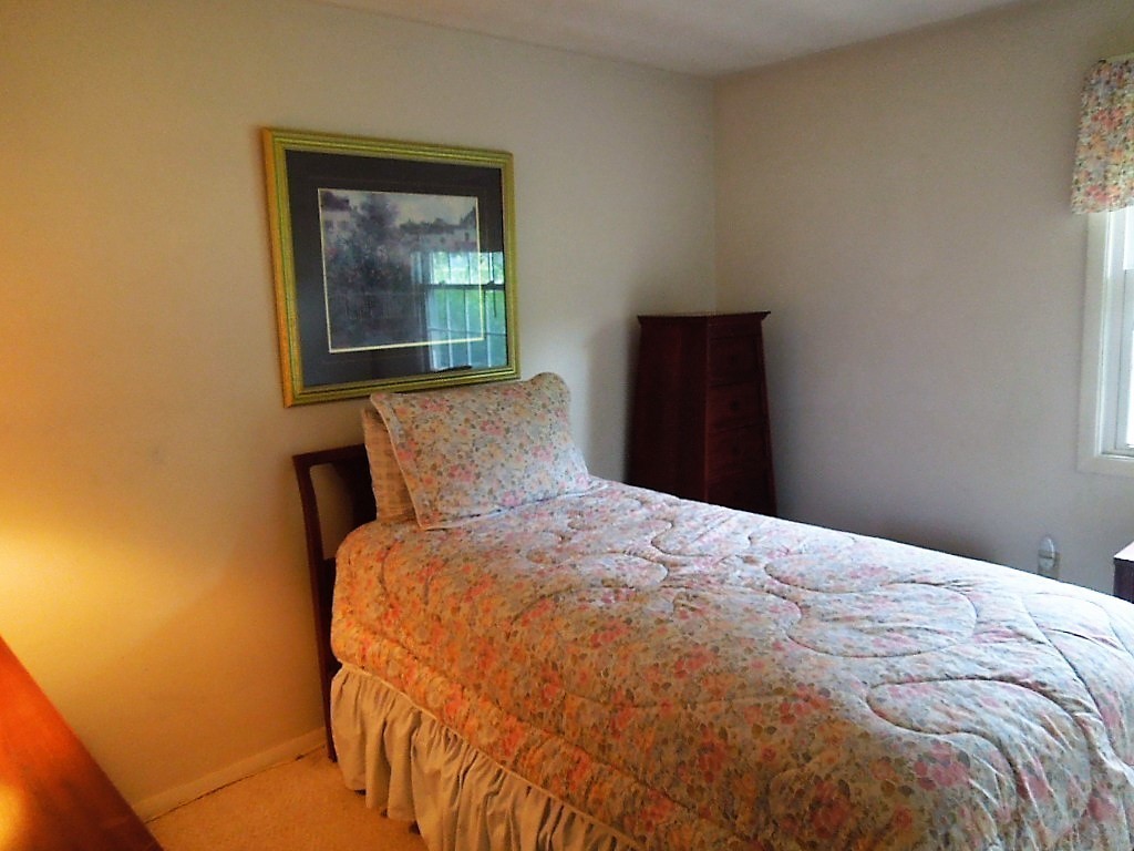 8 Howard Road Chelmsford, MA 01824 - Photo 19 of 30 a bed sitting in a bedroom next to a window