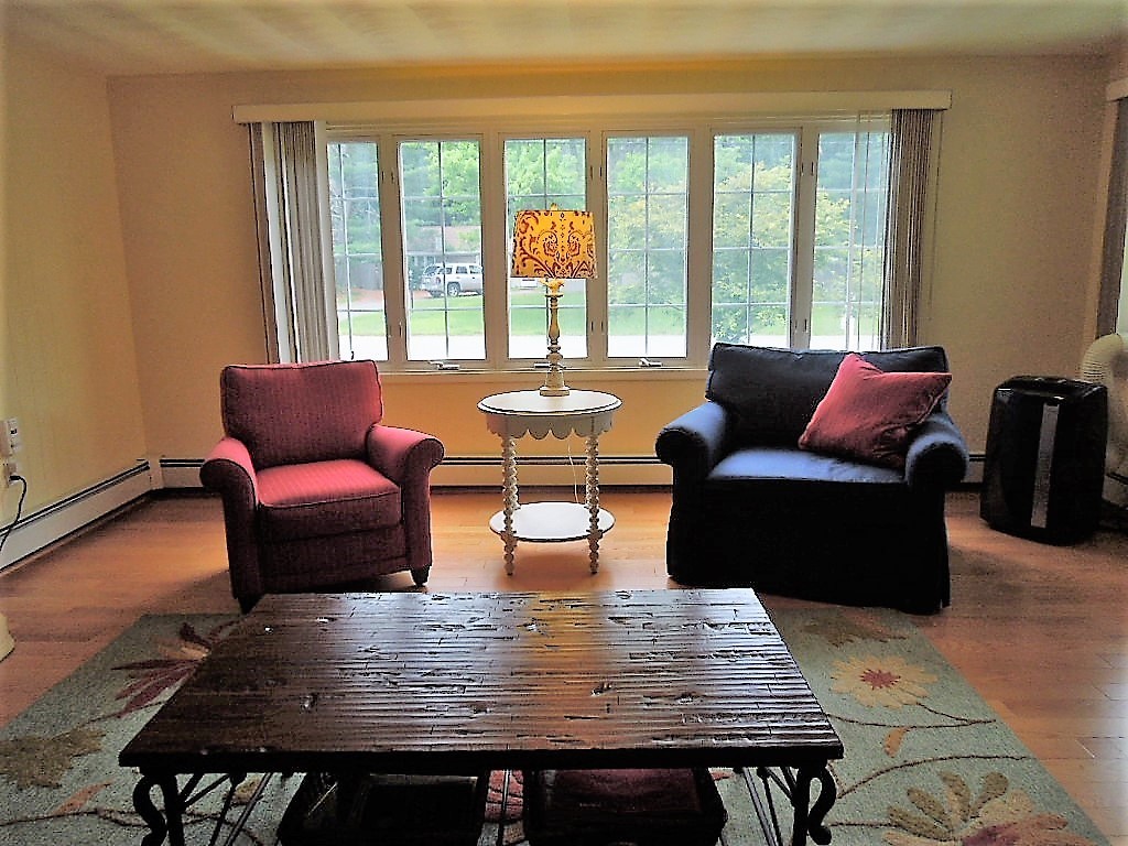 8 Howard Road Chelmsford, MA 01824 - Photo 6 of 30 a living room with furniture wooden floor and a floor to ceiling window