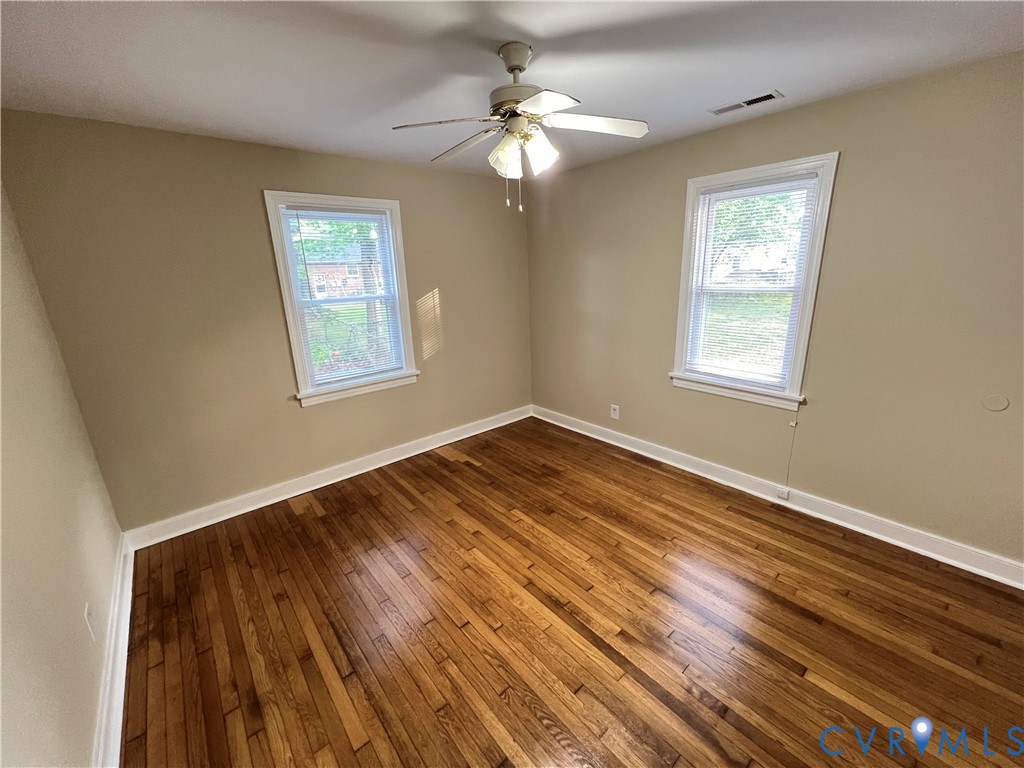 901 Ridgecliff Drive Richmond, VA 23224 - Photo 5 of 8 a view of an empty room with wooden floor and a window