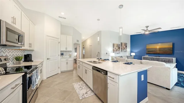 a bedroom with a bed a flat screen tv and a couch