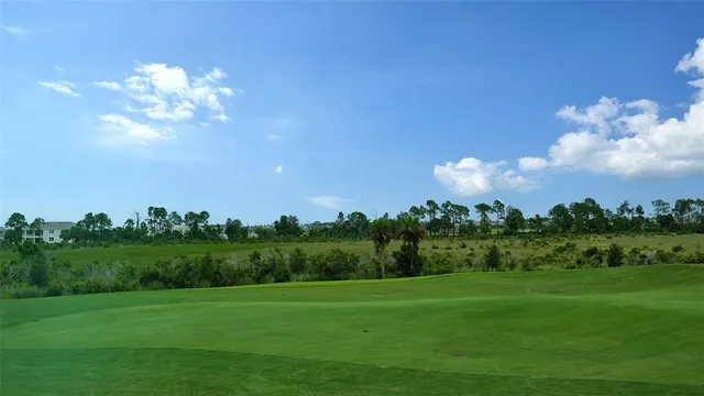 a front view of a house with a yard and potted plants