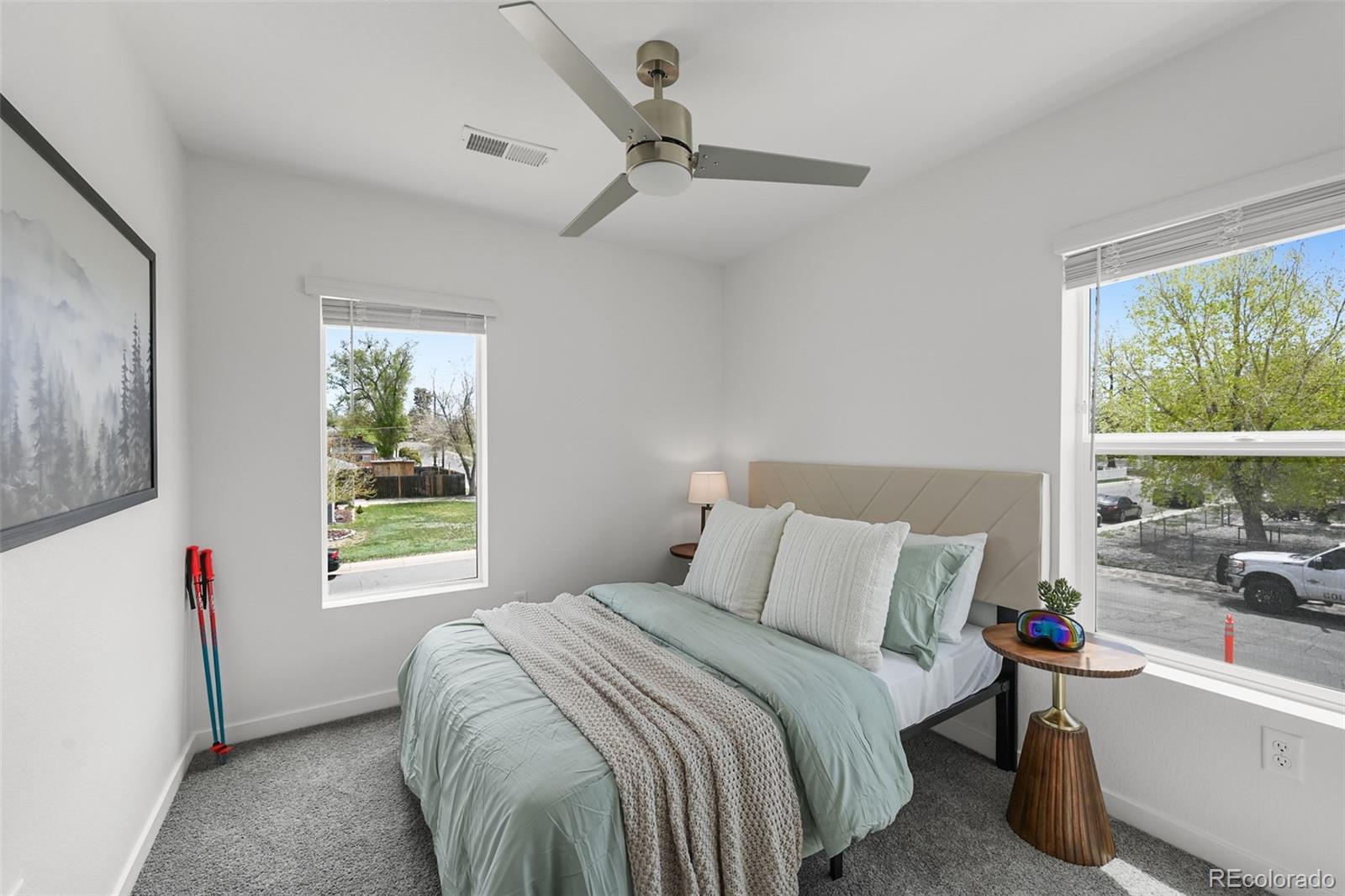 1304 Akron Street Aurora, CO 80010 - Photo 16 of 28 a bedroom with a bed and a large window