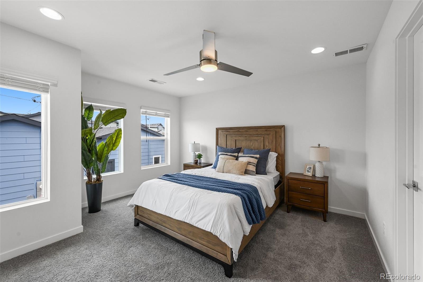 1304 Akron Street Aurora, CO 80010 - Photo 21 of 28 a bedroom with a bed and a window