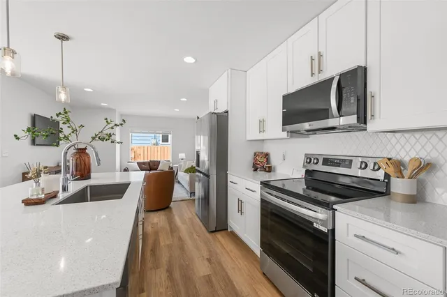 a kitchen with a sink a stove and microwave
