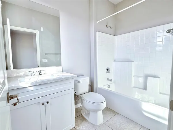 a bathroom with a sink toilet vanity and shower