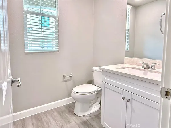 a bathroom with a toilet sink and a mirror