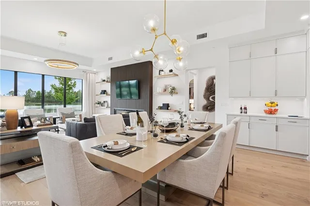 a living room with kitchen island furniture and a chandelier