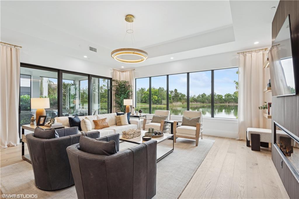19781 Marino Lake Circle, Unit B4101 Miromar Lakes, FL 33913 - Photo 18 of 44 a living room with furniture and a large window