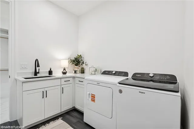 a utility room with sink dryer and washer