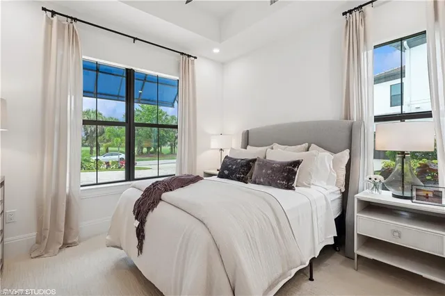 a bed sitting in a bedroom next to a window