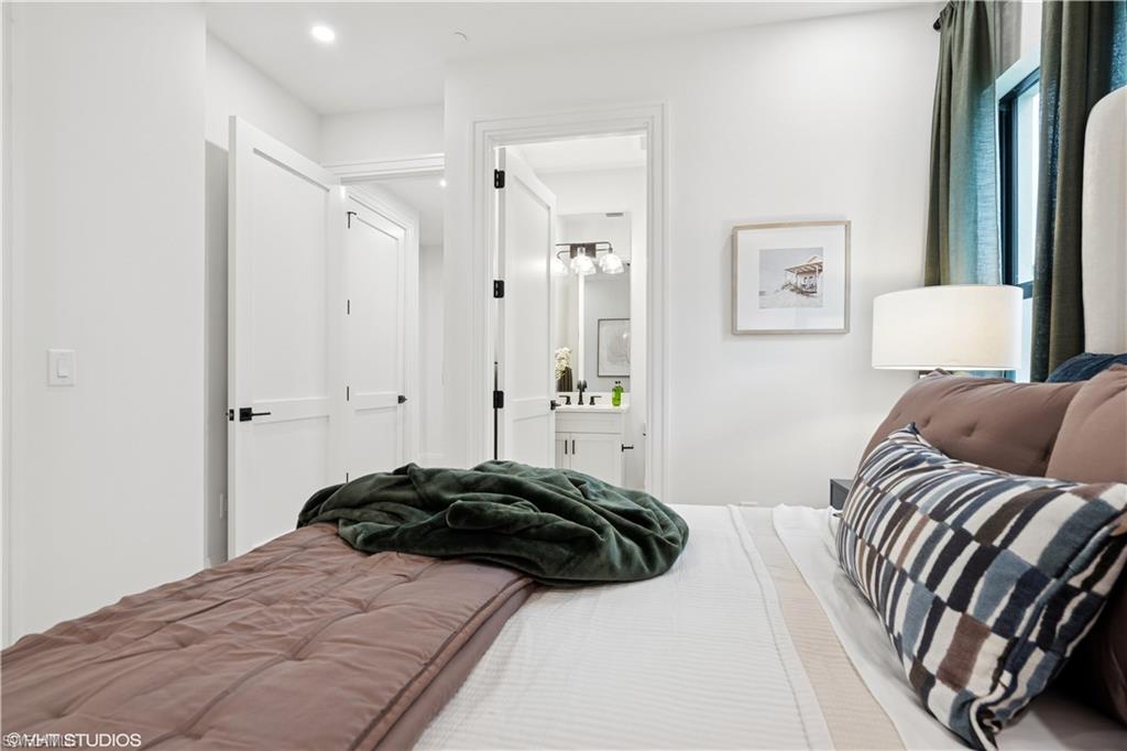 19781 Marino Lake Circle, Unit B4101 Miromar Lakes, FL 33913 - Photo 43 of 44 a bedroom with a bed and a painting