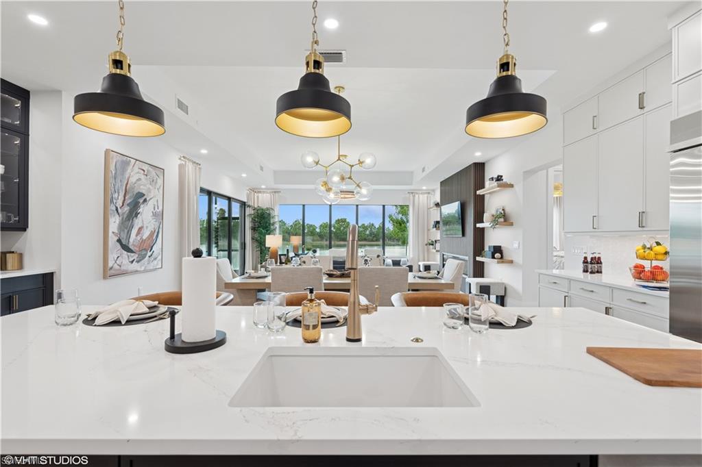 19781 Marino Lake Circle, Unit B4101 Miromar Lakes, FL 33913 - Photo 9 of 44 a kitchen with a table and chairs