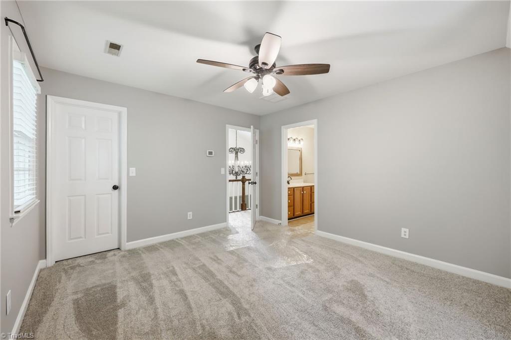 8861 Boylston Road Colfax, NC 27235 - Photo 27 of 50 Spacious secondary bedroom with new carpet (2026), generous closet space, and direct access to a full bath.