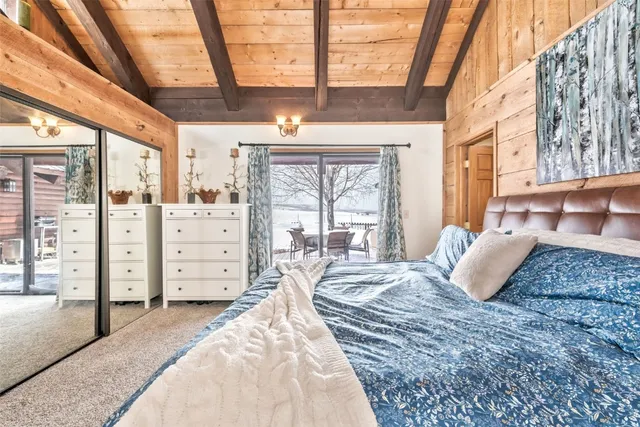 a bedroom with a bed and large window