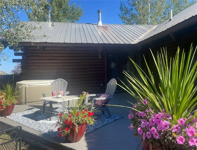 a front view of a house with outdoor seating