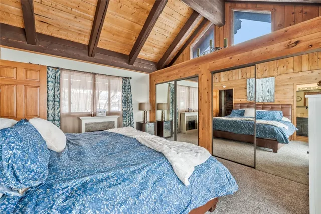 a spacious bedroom with a large bed and a balcony