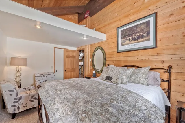 a bedroom with a large bed and a window