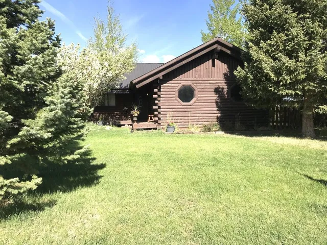 a view of a patio with table and chairs with wooden fence and plants