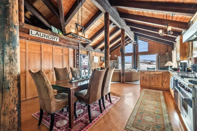 a dining room with furniture a chandelier and wooden floor
