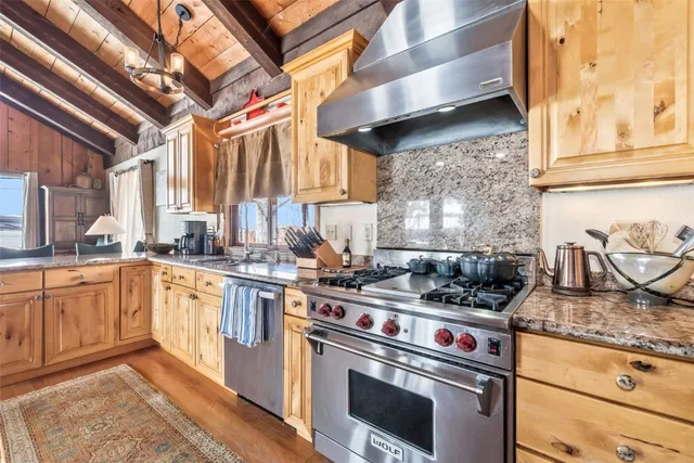 a kitchen with stainless steel appliances granite countertop a stove and a sink