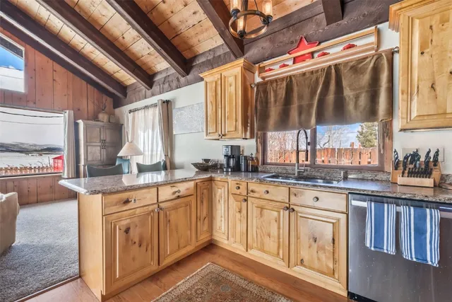 a kitchen with wooden cabinets and sink