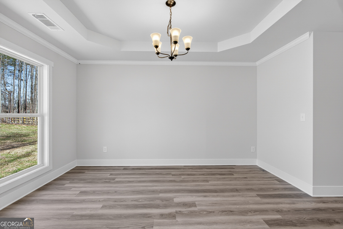 140 Chad Walk, Unit 57 Statham, GA 30666 - Photo 12 of 36 a view of an empty room with wooden floor and a window