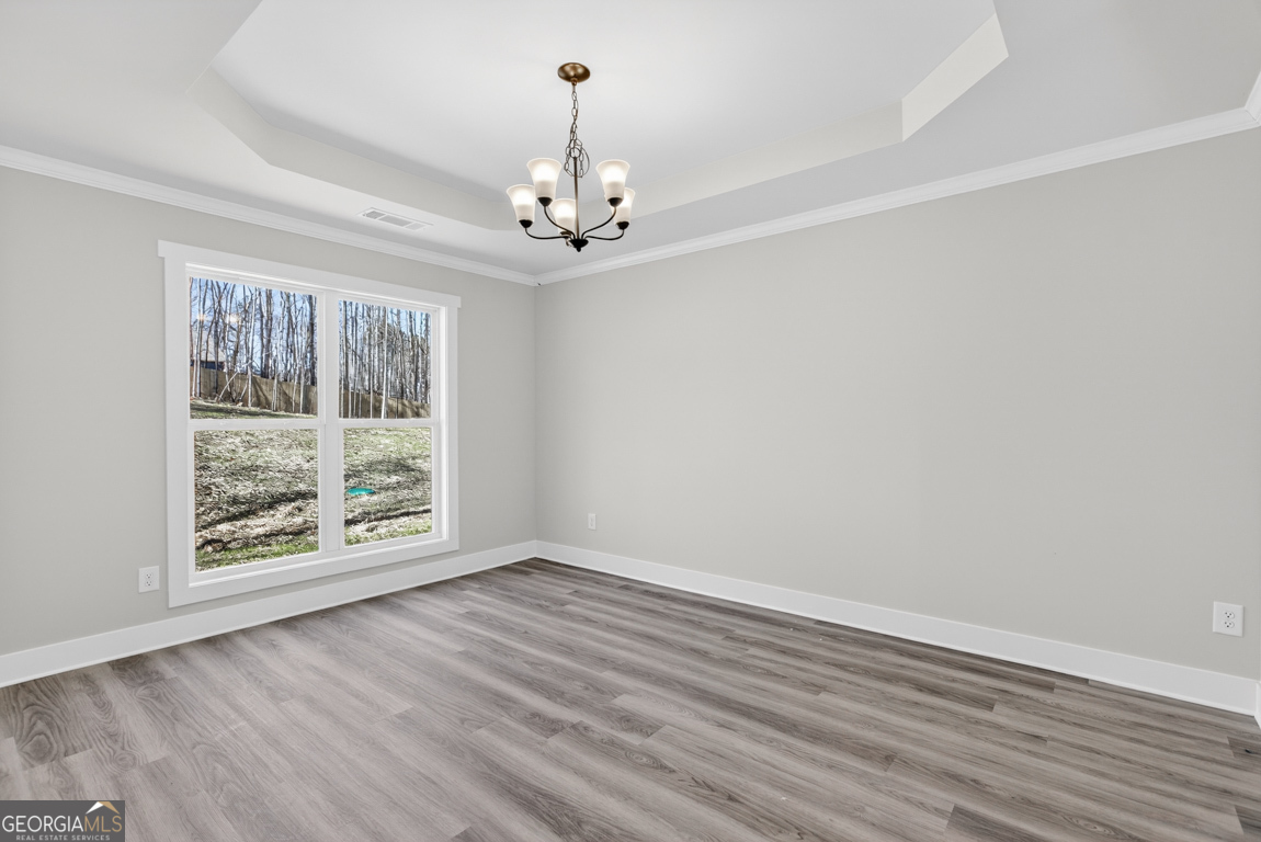 140 Chad Walk, Unit 57 Statham, GA 30666 - Photo 13 of 36 wooden floor in an empty room with a window